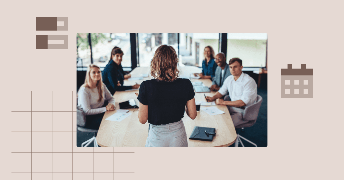 Project manager leading a presentation during a team meeting at a conference table.