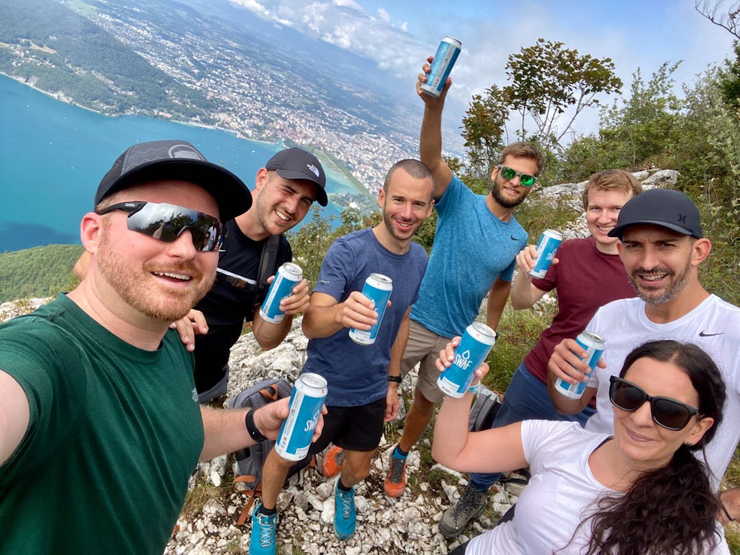 WEDO employees drinking beer on a mountain