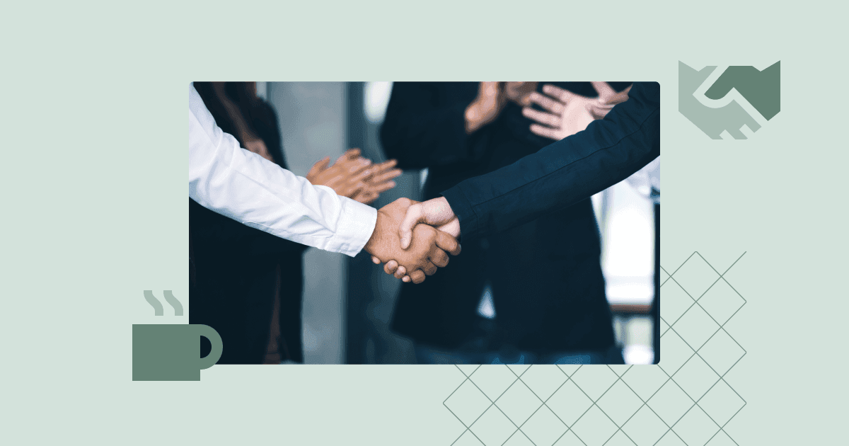 Two professionals shaking hands in an office while colleagues applaud, representing employee onboarding and welcoming procedures.