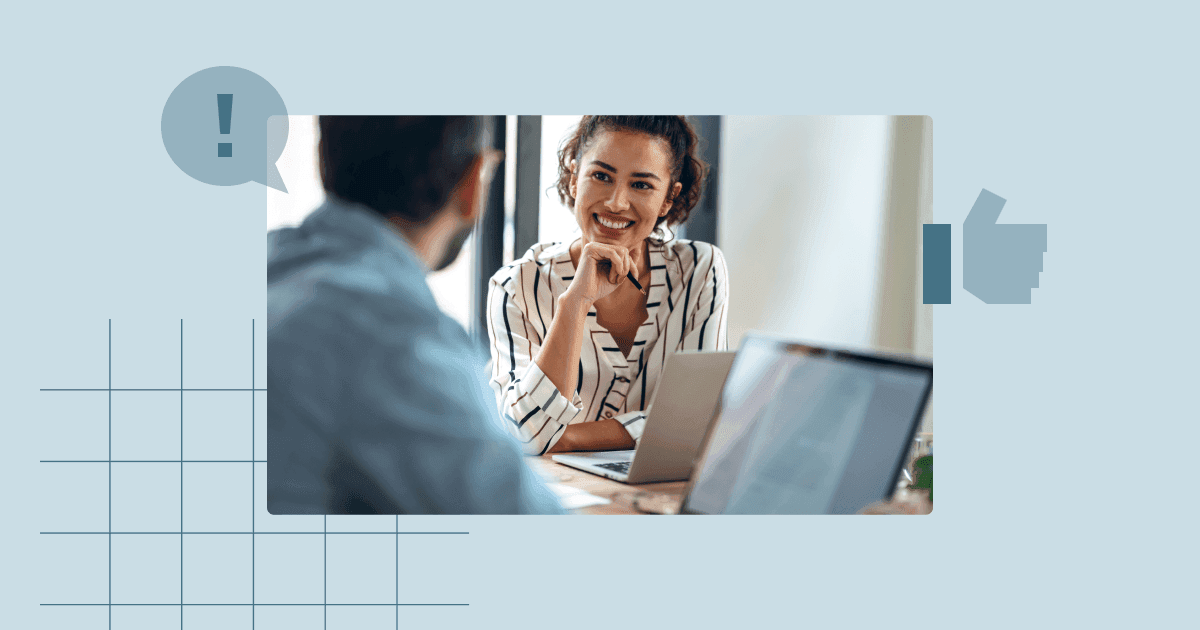 Executive assistant smiling while discussing with a colleague in an office, illustrating daily administrative workflow and support.