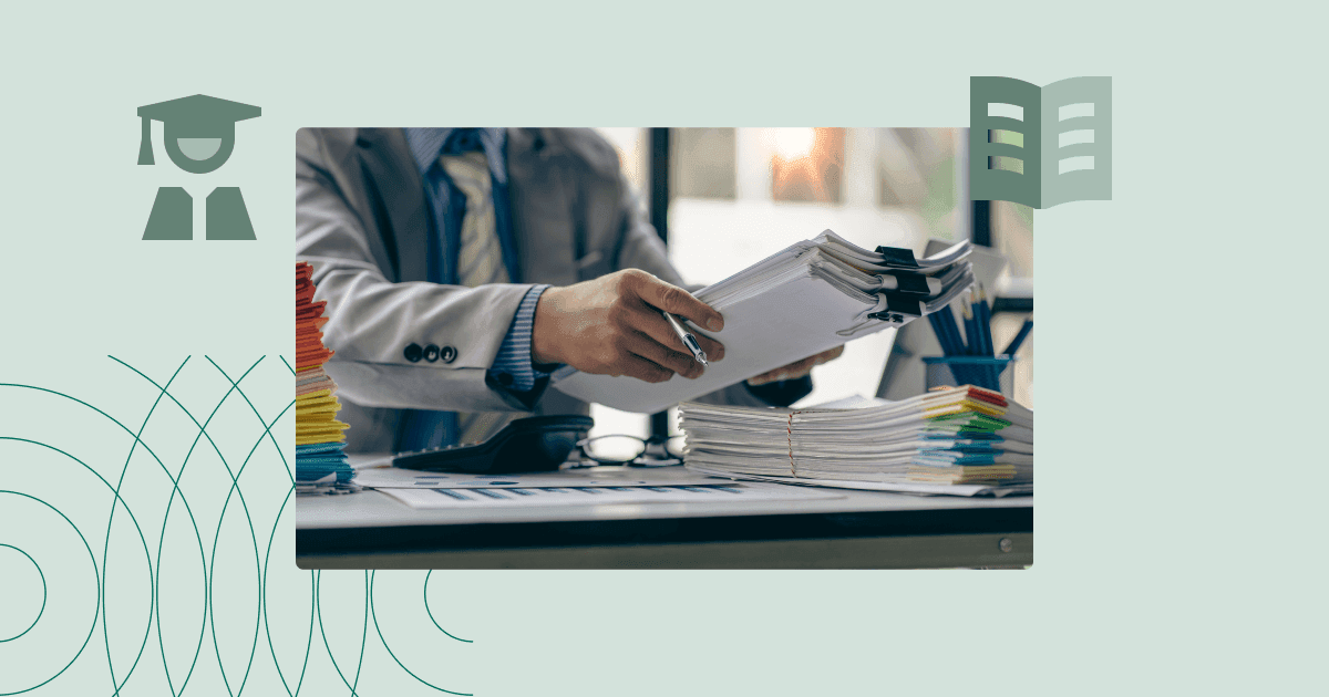 Person reviewing large stacks of paper documents on an office desk, illustrating the need for process automation.